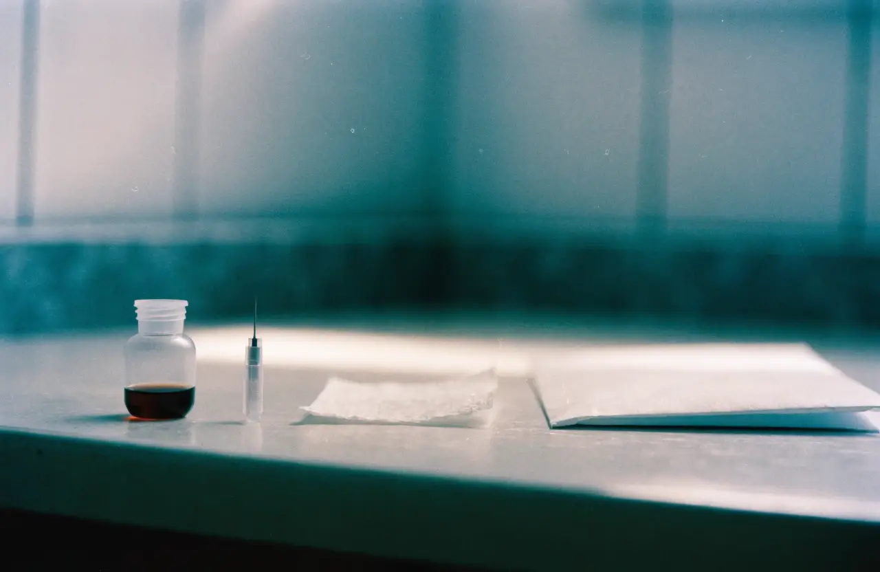 A home finger-prick blood test kit laid out on a kitchen table